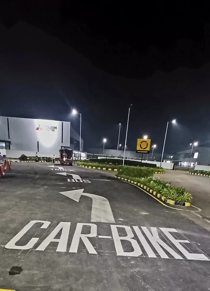 CAR-BIKE directional arrow and roundabout signage at an industrial facility