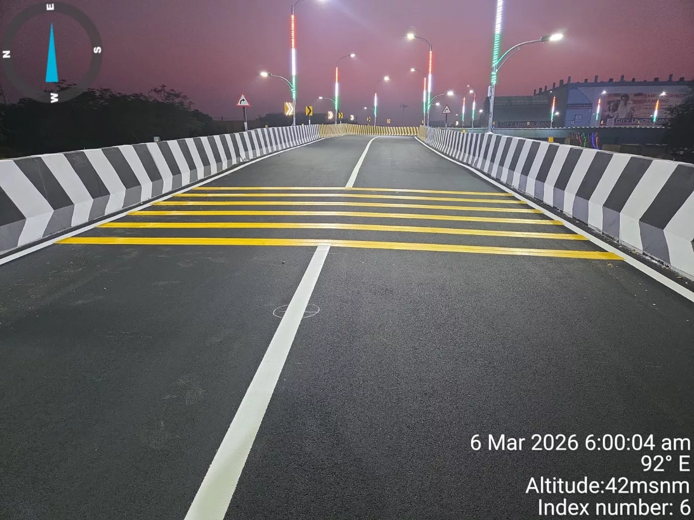 Completed road marking and chevron delineators on a flyover carriageway at night