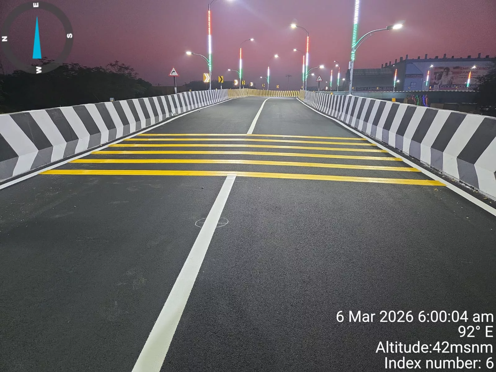 Completed road marking and reflective rumble-strip marking on a flyover carriageway at night