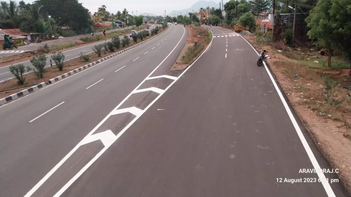Completed give-way chevron and lane marking on a divided highway with hill backdrop