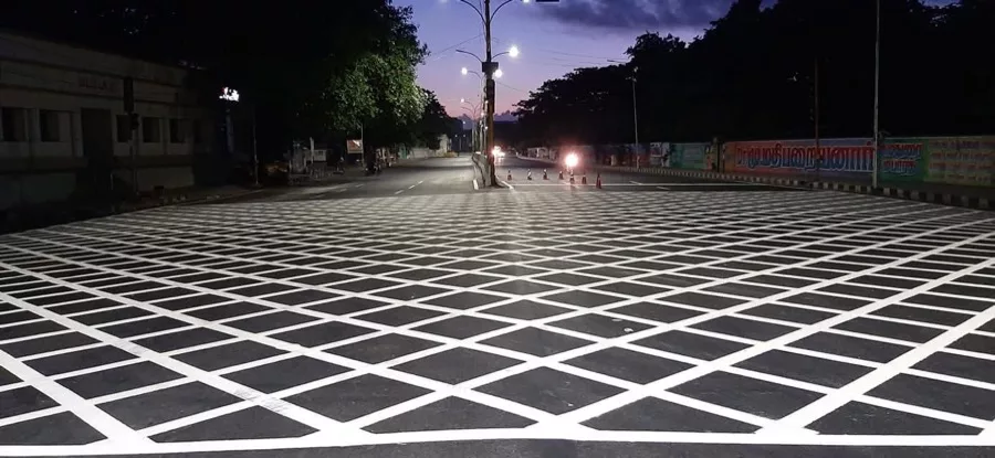 Completed thermoplastic box-grid junction road marking at dusk