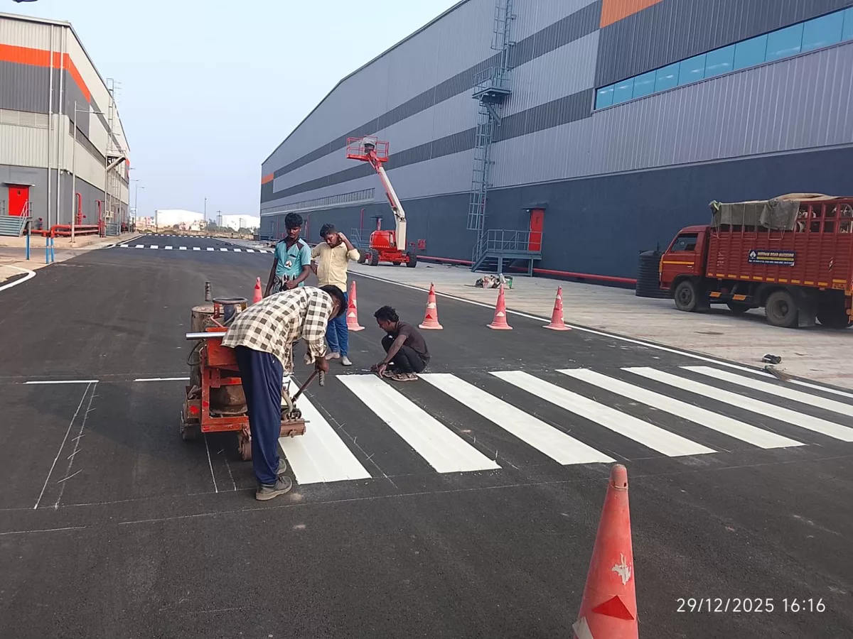 Deepam Road Marking crew applying a thermoplastic zebra crossing with a hand-guided applicator